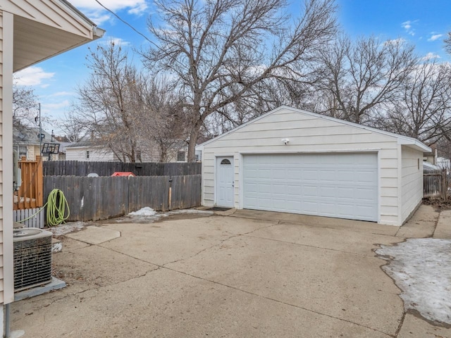 detached garage featuring central AC and fence