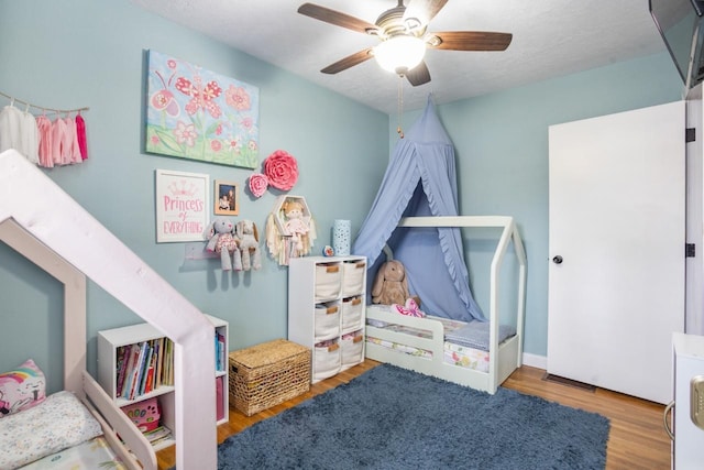 bedroom featuring wood finished floors and a ceiling fan