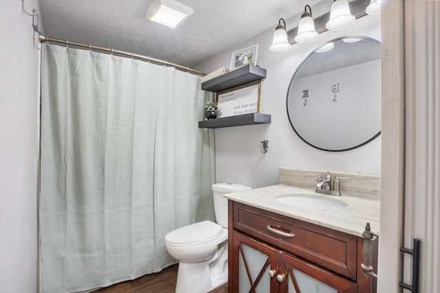 full bath with a textured ceiling, toilet, a shower with shower curtain, wood finished floors, and vanity