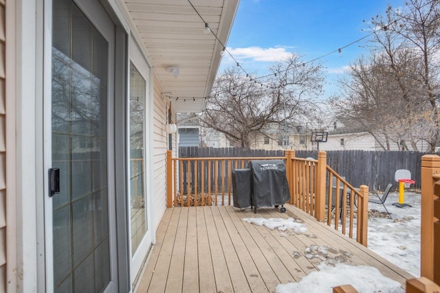 deck with a fenced backyard and a grill