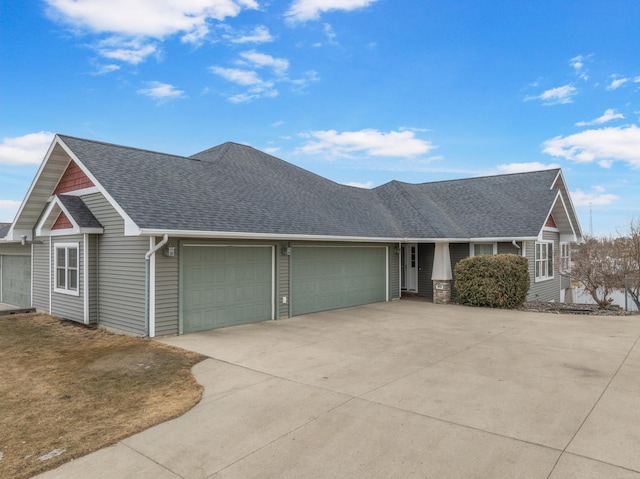 single story home featuring a garage, roof with shingles, and driveway