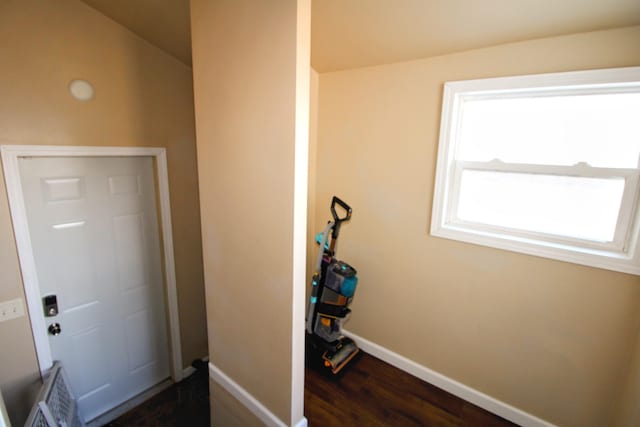 entryway with dark wood finished floors and baseboards