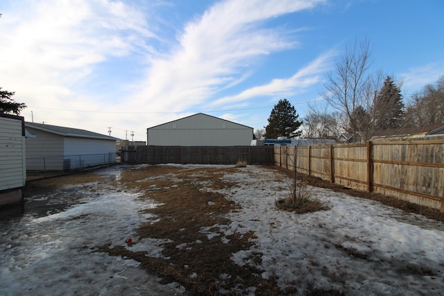 yard covered in snow featuring a fenced backyard