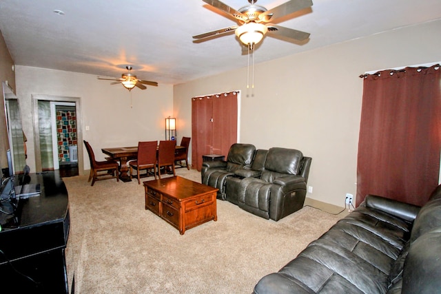 living area with carpet and a ceiling fan