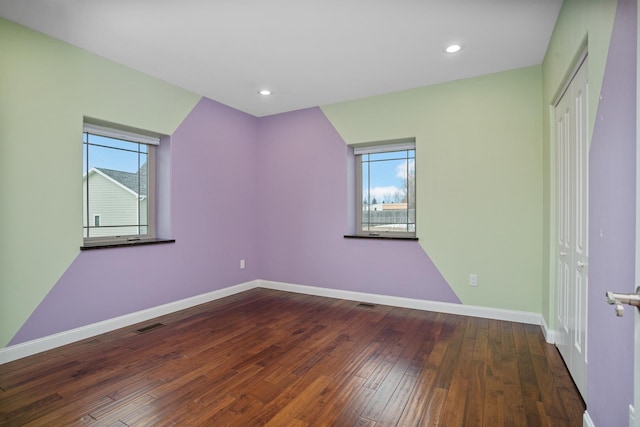 unfurnished bedroom with recessed lighting, wood-type flooring, visible vents, and baseboards