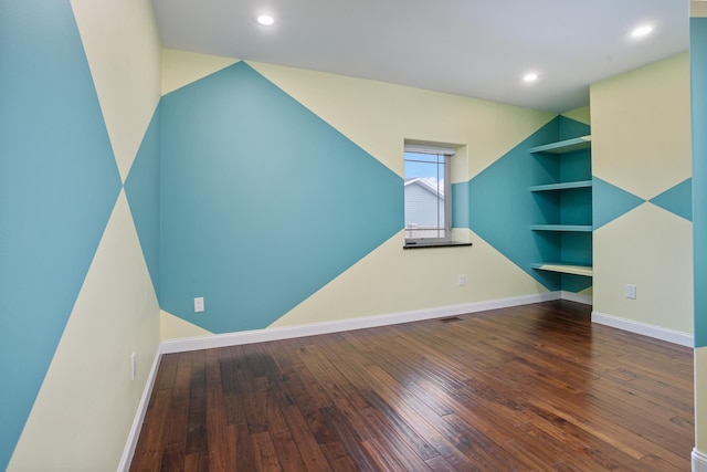 additional living space featuring built in shelves, recessed lighting, baseboards, and hardwood / wood-style floors