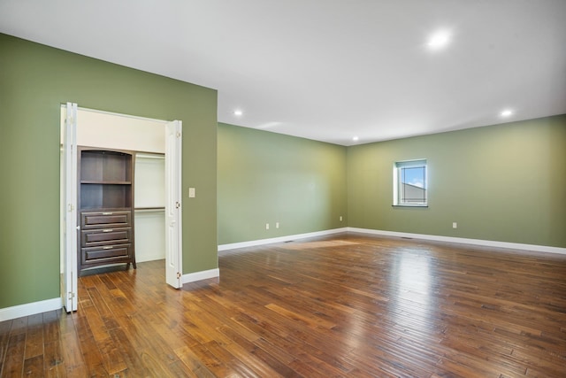 interior space with dark wood-style flooring, recessed lighting, and baseboards