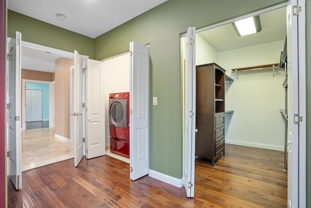 interior space featuring washer / dryer, baseboards, and dark wood-style flooring