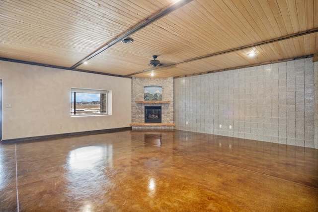 unfurnished living room featuring a fireplace, wood ceiling, and baseboards