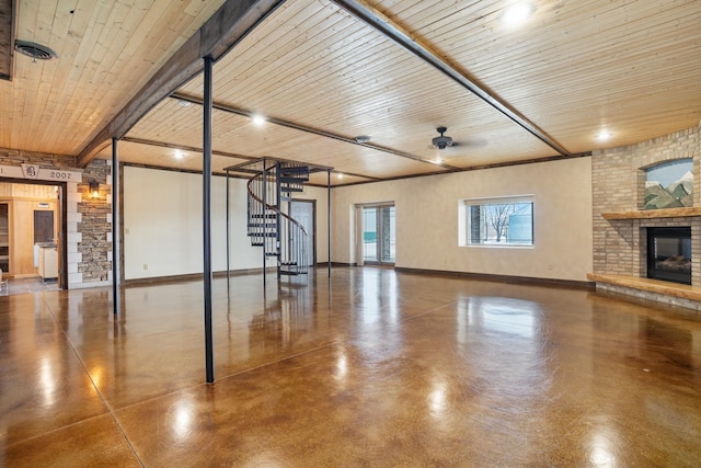 unfurnished living room with a fireplace, wood ceiling, baseboards, stairs, and finished concrete floors