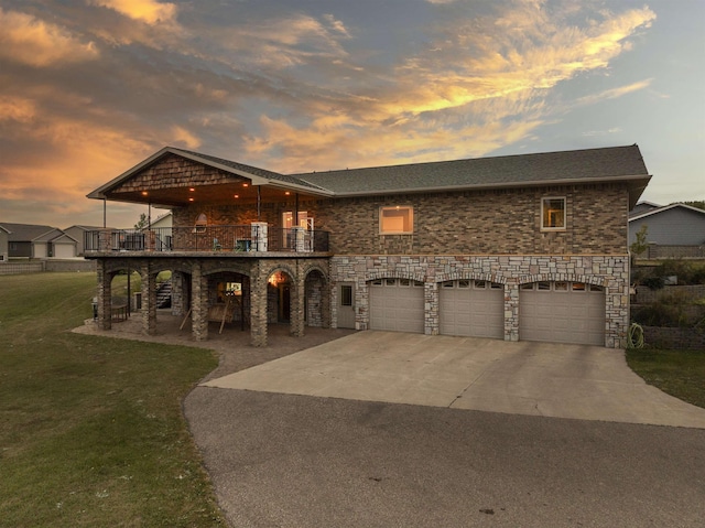 view of front of home featuring a garage, concrete driveway, a patio area, and a front lawn