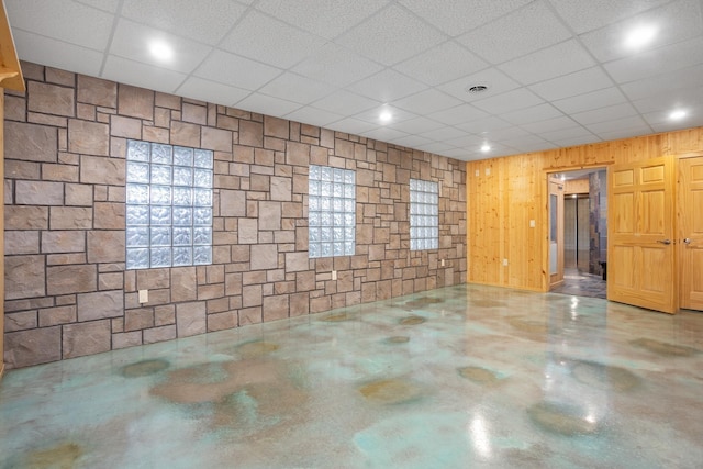 spare room featuring finished concrete floors, visible vents, and a drop ceiling
