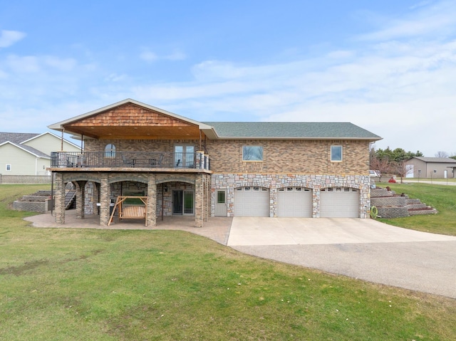 view of front of home with brick siding, an attached garage, a front yard, a balcony, and driveway
