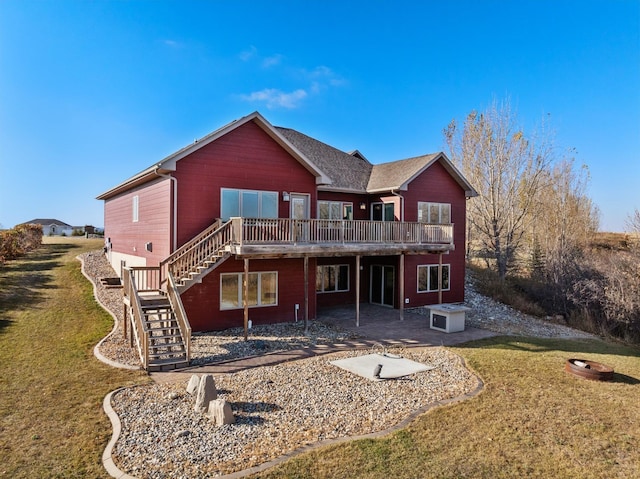 back of property with stairway, a deck, a patio, and a yard