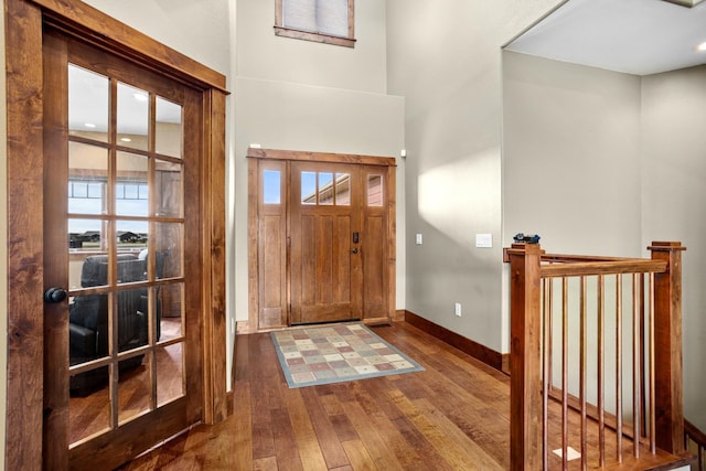 entryway with hardwood / wood-style flooring and baseboards