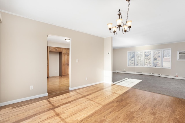 unfurnished room with a baseboard heating unit, baseboards, light wood-style floors, an inviting chandelier, and crown molding