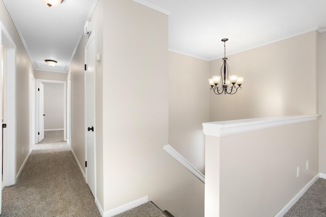 corridor with carpet floors, ornamental molding, and an upstairs landing