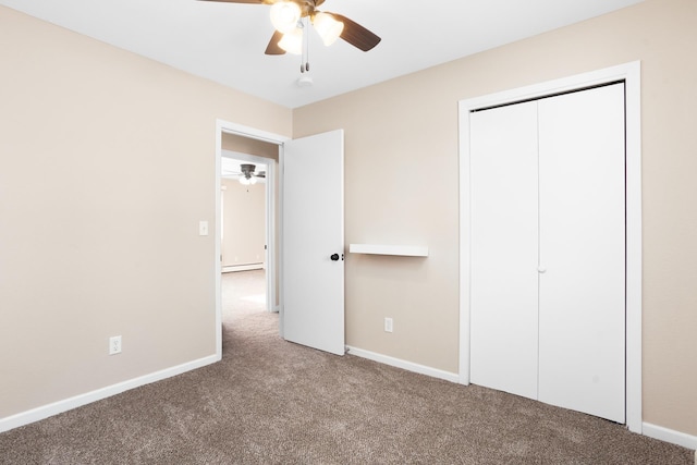 unfurnished bedroom with carpet floors, baseboards, and baseboard heating