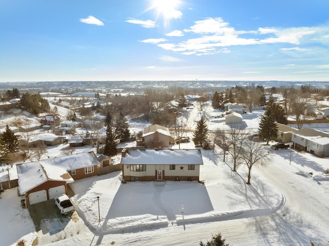 snowy aerial view with a residential view