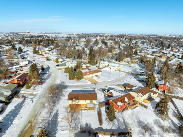 snowy aerial view with a residential view