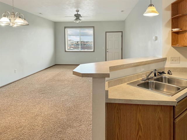 kitchen featuring a sink, light colored carpet, a peninsula, brown cabinetry, and open shelves