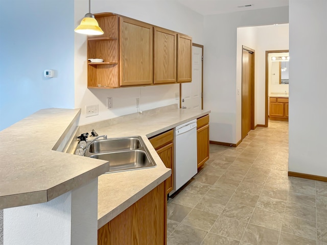 kitchen featuring a sink, decorative light fixtures, a peninsula, light countertops, and dishwasher