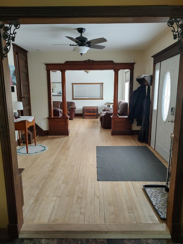 entrance foyer with hardwood / wood-style floors, a ceiling fan, and baseboards