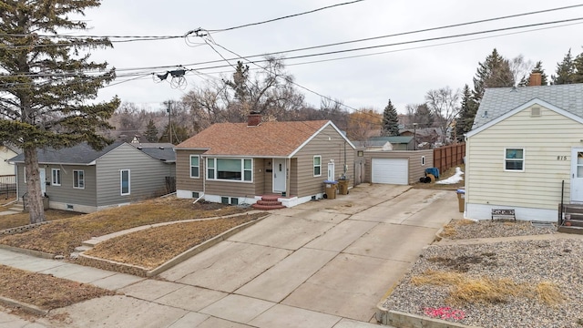 bungalow-style home featuring an outbuilding, fence, a chimney, entry steps, and concrete driveway