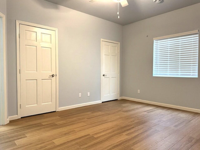 unfurnished bedroom featuring light wood-type flooring and baseboards