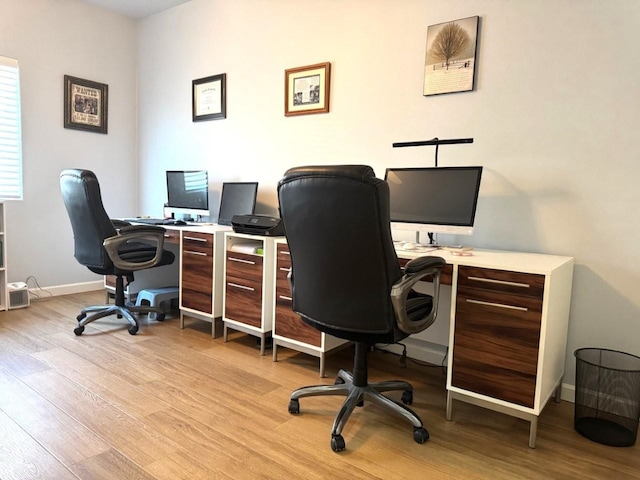 office with light wood-type flooring and baseboards