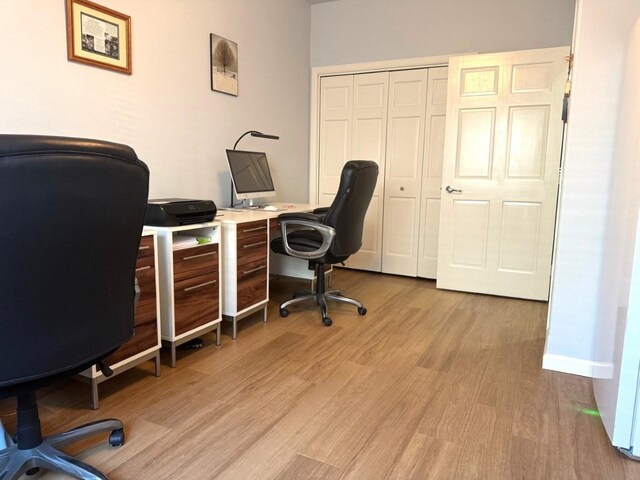 office with baseboards and light wood-style floors