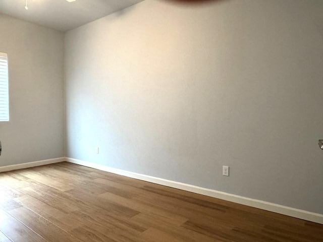 empty room with wood finished floors and baseboards