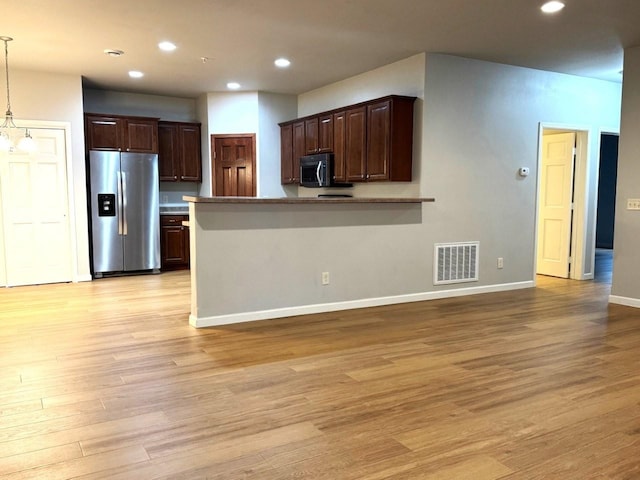 kitchen featuring visible vents, appliances with stainless steel finishes, and light wood-style floors