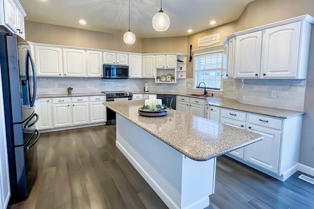 kitchen with fridge with ice dispenser, electric range, stainless steel microwave, white cabinetry, and dishwasher