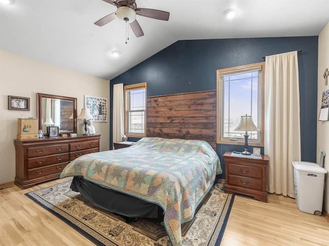 bedroom featuring lofted ceiling, light wood-type flooring, and ceiling fan