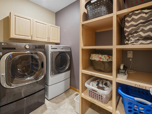 laundry area featuring washing machine and dryer and cabinet space