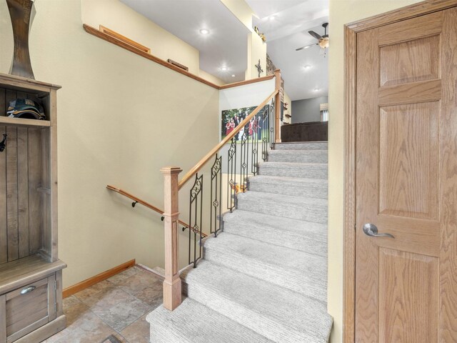 stairs with baseboards and ceiling fan