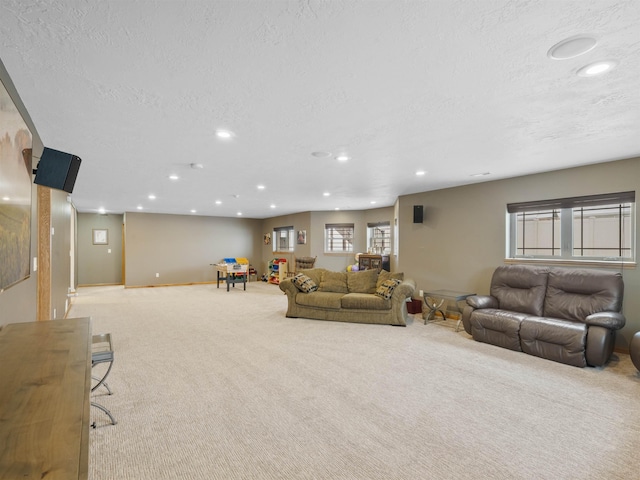 living room with recessed lighting, carpet, and a textured ceiling