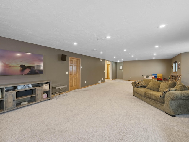 living area featuring recessed lighting, baseboards, carpet floors, and a textured ceiling