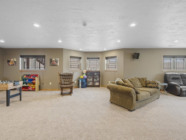 carpeted living room with a wealth of natural light, recessed lighting, and a textured ceiling