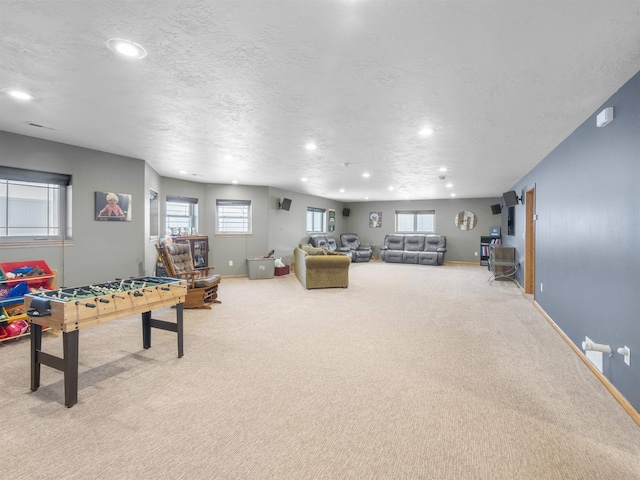 recreation room featuring recessed lighting, baseboards, a textured ceiling, and carpet flooring