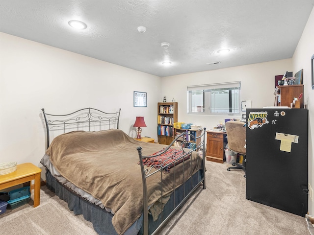 bedroom with visible vents and light carpet