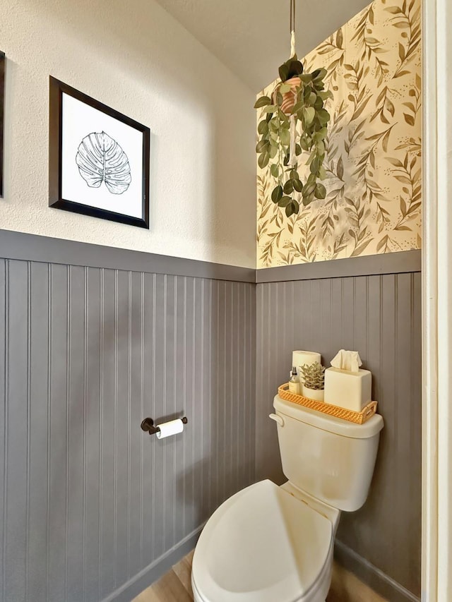 bathroom featuring toilet and wainscoting