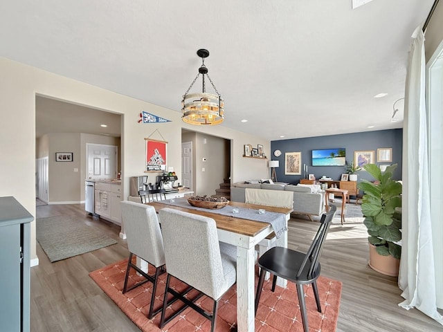 dining space featuring an inviting chandelier, recessed lighting, baseboards, and light wood finished floors