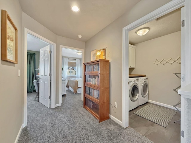 interior space featuring washer and clothes dryer, cabinet space, and baseboards