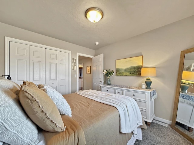 carpeted bedroom with baseboards and a closet