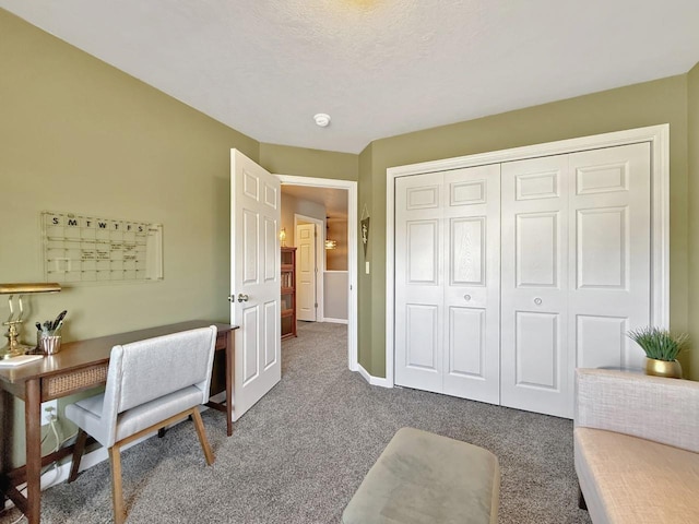 home office with baseboards, a textured ceiling, and carpet flooring