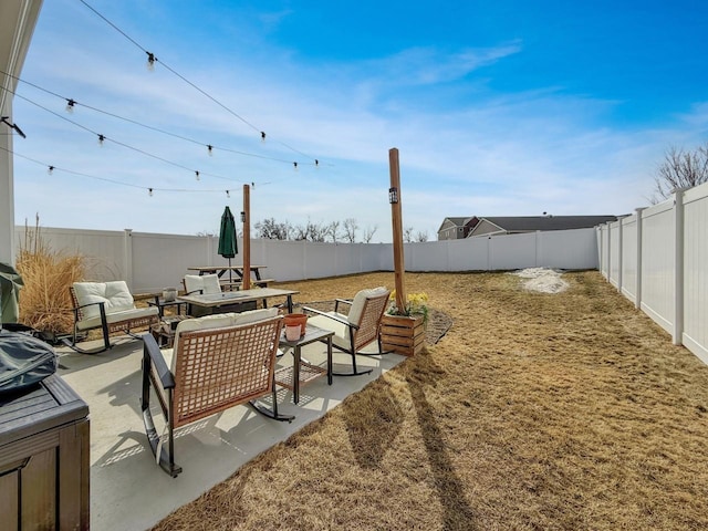 view of yard with a fenced backyard, an outdoor hangout area, and a patio