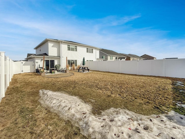 rear view of house featuring a patio area and a fenced backyard