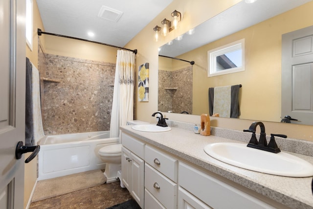 bathroom featuring visible vents, toilet, shower / bath combo with shower curtain, and a sink